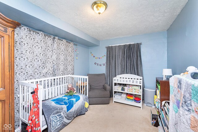 carpeted bedroom featuring a textured ceiling