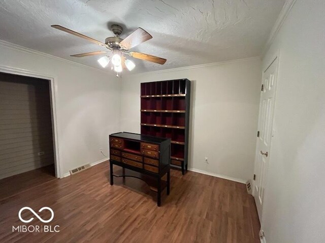 1054 Carters Grv, Indianapolis, IN 46260 - unfurnished bedroom featuring wood finished floors, ornamental molding, baseboards, a textured ceiling, and ceiling fan