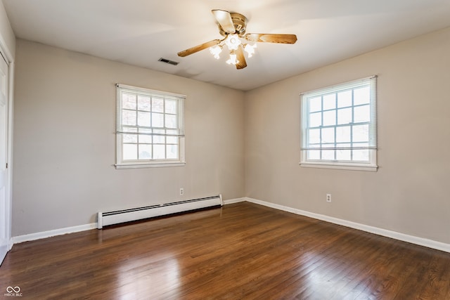 7859 N Chester Ave, Indianapolis, IN 46240 - empty room featuring baseboard heating, plenty of natural light, and wood finished floors