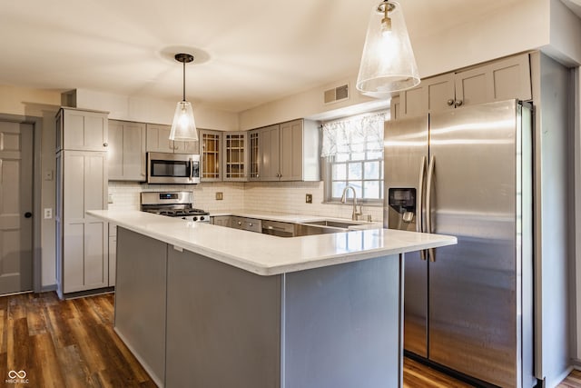 7859 N Chester Ave, Indianapolis, IN 46240 - kitchen featuring appliances with stainless steel finishes, gray cabinetry, a sink, glass insert cabinets, and decorative backsplash