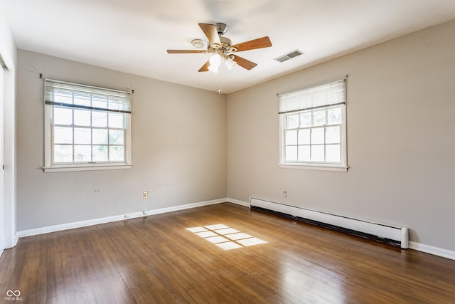 7859 N Chester Ave, Indianapolis, IN 46240 - unfurnished room featuring baseboard heating, healthy amount of natural light, wood finished floors, and ceiling fan