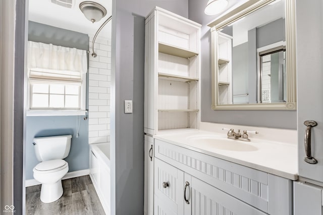 7859 N Chester Ave, Indianapolis, IN 46240 - full bath featuring vanity, toilet, wood finished floors, and  shower combination
