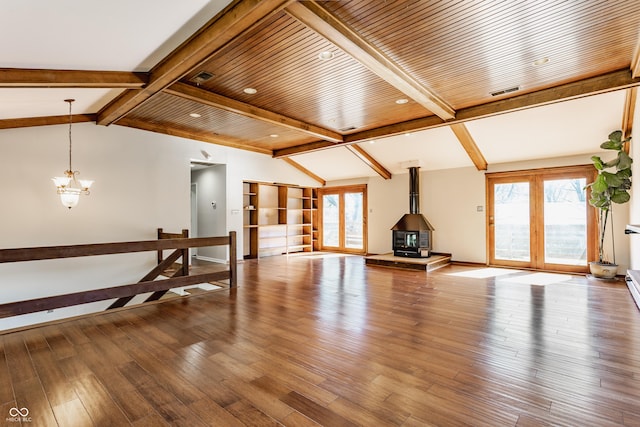 7859 N Chester Ave, Indianapolis, IN 46240 - unfurnished living room featuring healthy amount of natural light, hardwood / wood-style floors, a wood stove, and a chandelier
