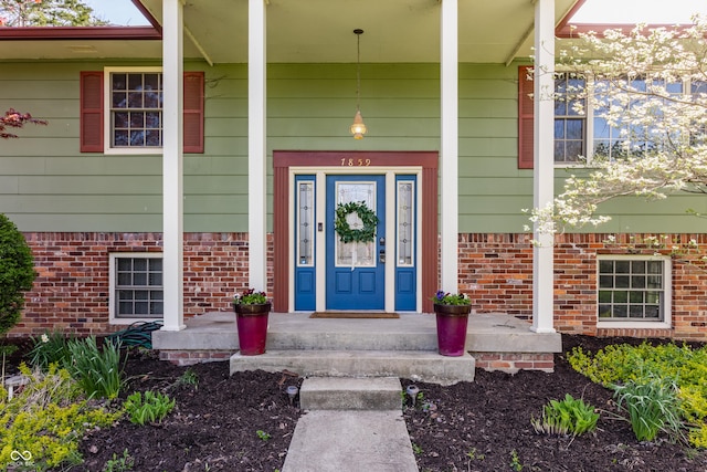7859 N Chester Ave, Indianapolis, IN 46240 - view of exterior entry featuring covered porch and brick siding