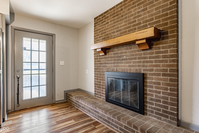 7859 N Chester Ave, Indianapolis, IN 46240 - unfurnished living room with wood finished floors, a fireplace, and plenty of natural light