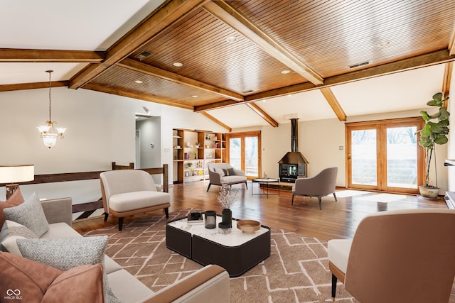 7859 N Chester Ave, Indianapolis, IN 46240 - living area with wood finished floors, plenty of natural light, a chandelier, and a wood stove