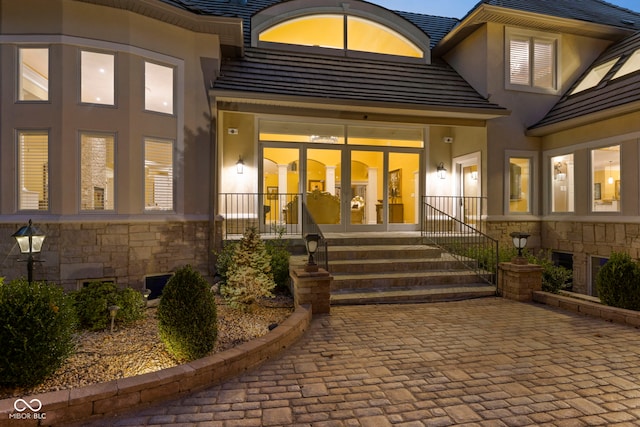 10821 Club Point Dr, Fishers, IN 46037 - doorway to property featuring stone siding, a tile roof, and stucco siding