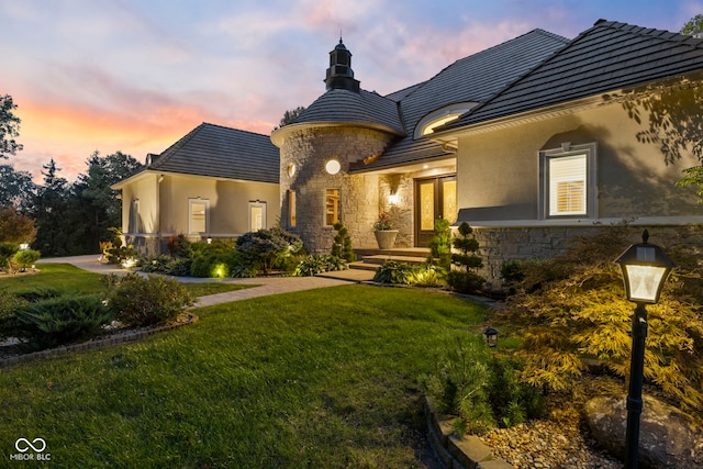 10821 Club Point Dr, Fishers, IN 46037 - view of front of house with stone siding, french doors, stucco siding, and a lawn