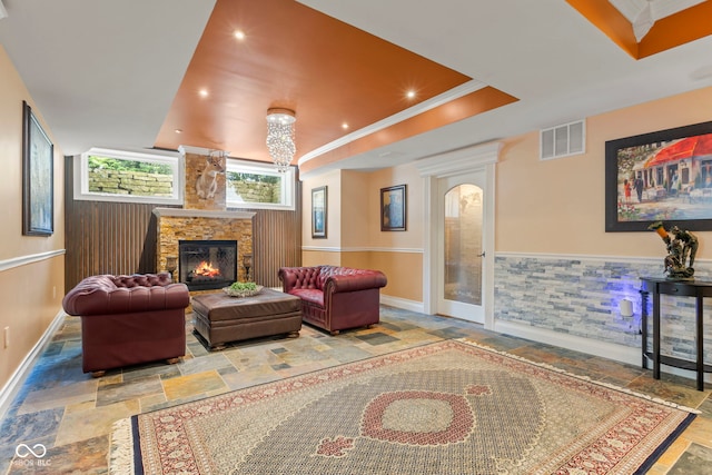 10821 Club Point Dr, Fishers, IN 46037 - living area with stone tile floors, recessed lighting, ornamental molding, a wainscoted wall, and a fireplace