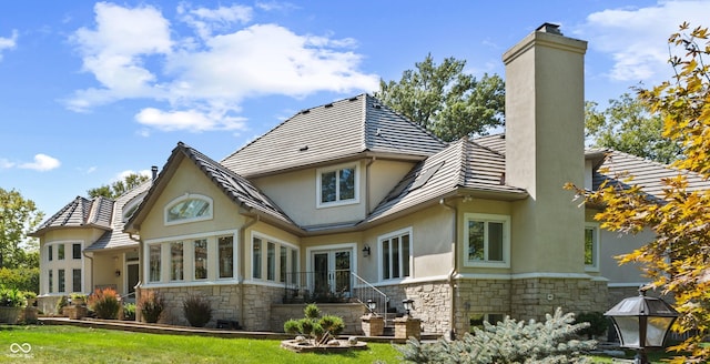 10821 Club Point Dr, Fishers, IN 46037 - back of property featuring stone siding, a chimney, french doors, and stucco siding