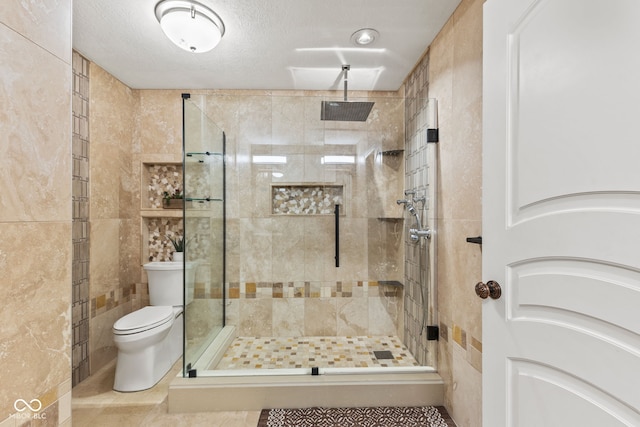 10821 Club Point Dr, Fishers, IN 46037 - full bath featuring tile walls, toilet, a textured ceiling, a shower stall, and tile patterned floors