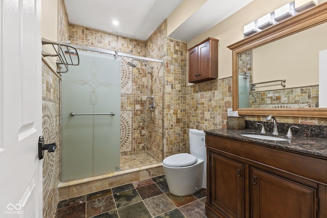 10821 Club Point Dr, Fishers, IN 46037 - bathroom with a stall shower, toilet, stone tile floors, vanity, and tile walls