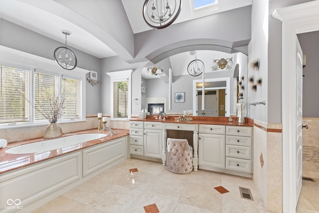 10821 Club Point Dr, Fishers, IN 46037 - bathroom with tiled shower, vanity, a chandelier, a bath, and visible vents