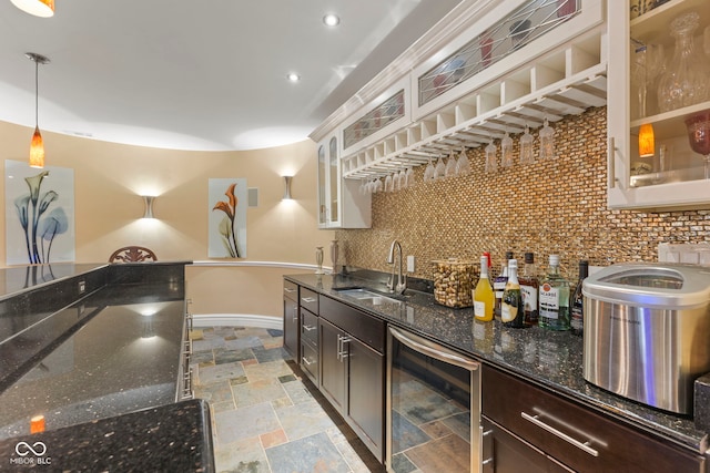 10821 Club Point Dr, Fishers, IN 46037 - kitchen featuring dark brown cabinetry, wine cooler, a sink, stone tile floors, and tasteful backsplash