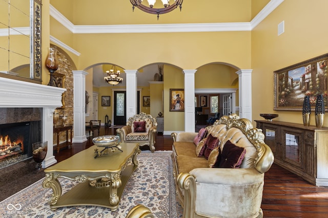 10821 Club Point Dr, Fishers, IN 46037 - living room with wood finished floors, arched walkways, a premium fireplace, and ornate columns