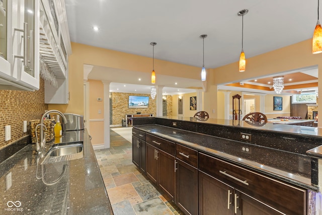 10821 Club Point Dr, Fishers, IN 46037 - kitchen with backsplash, a sink, open floor plan, stone tile flooring, and ornate columns