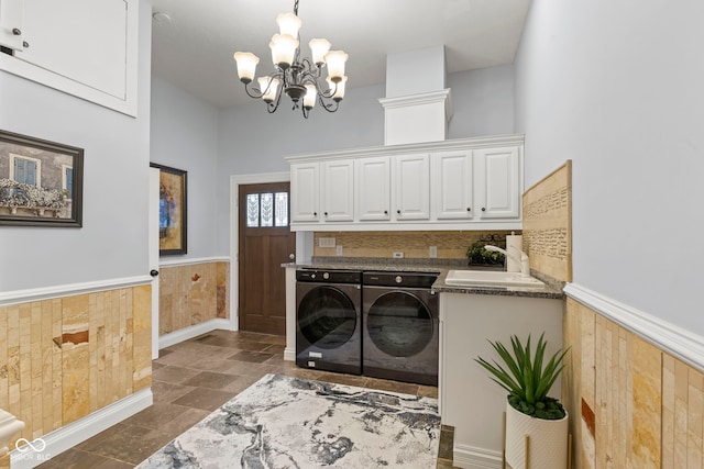 10821 Club Point Dr, Fishers, IN 46037 - washroom with a wainscoted wall, cabinet space, a sink, washing machine and dryer, and a notable chandelier