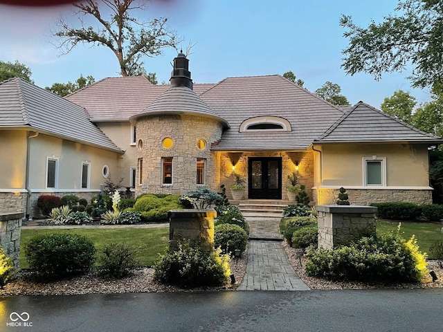10821 Club Point Dr, Fishers, IN 46037 - french country home featuring a front lawn, stucco siding, stone siding, and french doors