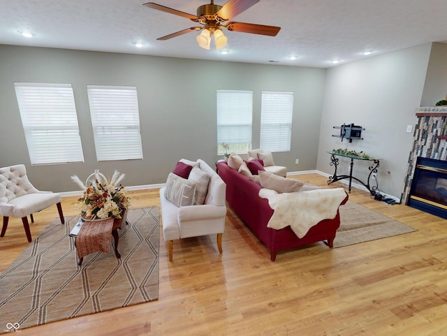 5180 Dunewood Way Unit 57, Avon, IN 46123 - living area featuring light wood-style flooring, recessed lighting, a ceiling fan, and a glass covered fireplace