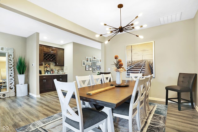 1684 Beach St, Greenwood, IN 46143 - dining space featuring baseboards, visible vents, light wood-style floors, and a notable chandelier