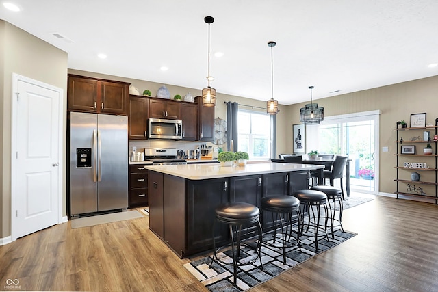 1684 Beach St, Greenwood, IN 46143 - kitchen featuring light countertops, a kitchen bar, light wood-type flooring, and appliances with stainless steel finishes
