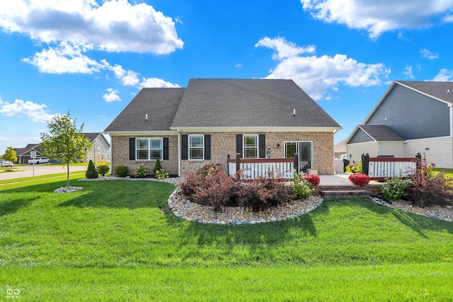 1684 Beach St, Greenwood, IN 46143 - view of front of property with brick siding, a shingled roof, a deck, and a front lawn