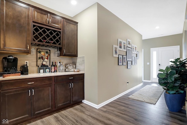 1684 Beach St, Greenwood, IN 46143 - bar with a bar, wood finished floors, baseboards, and decorative backsplash