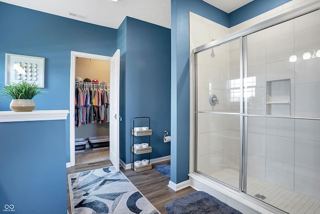 1684 Beach St, Greenwood, IN 46143 - full bath with baseboards, visible vents, a shower stall, and wood finished floors