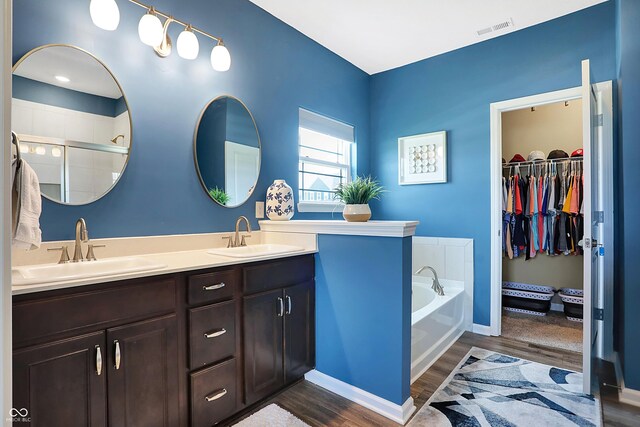 1684 Beach St, Greenwood, IN 46143 - full bath with wood finished floors, a sink, double vanity, and visible vents