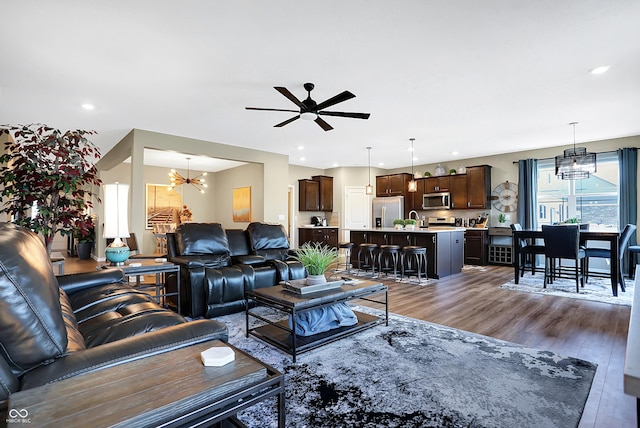 1684 Beach St, Greenwood, IN 46143 - living area with ceiling fan with notable chandelier, dark wood-type flooring, and recessed lighting