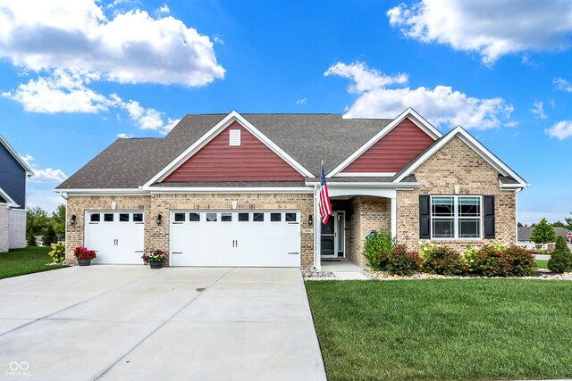 1684 Beach St, Greenwood, IN 46143 - craftsman-style home with brick siding, a garage, concrete driveway, and a front yard