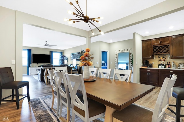 1684 Beach St, Greenwood, IN 46143 - dining room with wood finished floors, a chandelier, and bar area