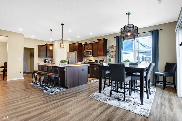 1684 Beach St, Greenwood, IN 46143 - dining area featuring light wood finished floors, baseboards, and recessed lighting