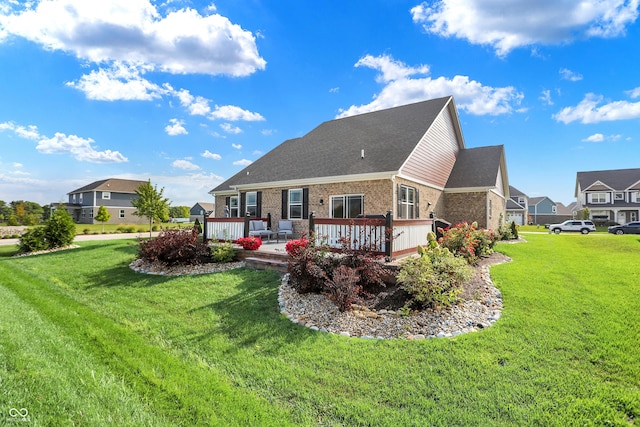 1684 Beach St, Greenwood, IN 46143 - rear view of property with a lawn, brick siding, and a deck