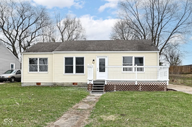view of front of home with crawl space, a wooden deck, a front lawn, and fence