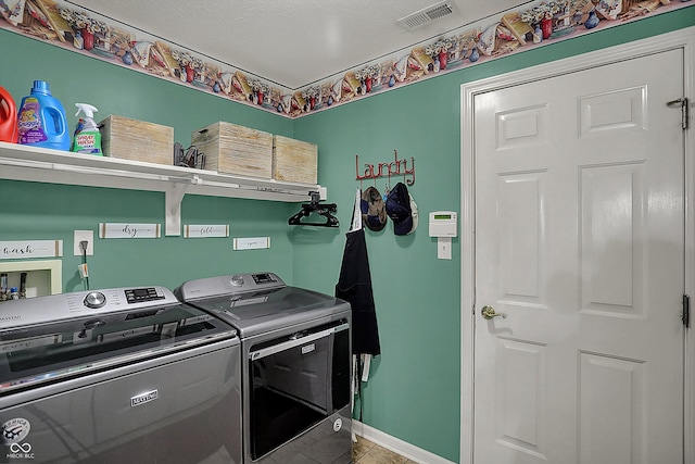 clothes washing area with visible vents, baseboards, separate washer and dryer, laundry area, and tile patterned floors