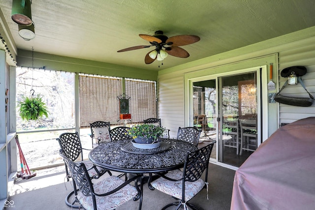 sunroom featuring ceiling fan and outdoor dining area