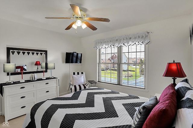 bedroom featuring a ceiling fan and multiple windows