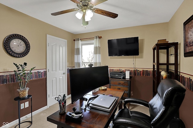 carpeted home office with ceiling fan