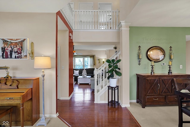 interior space with stairs, baseboards, and wood finished floors
