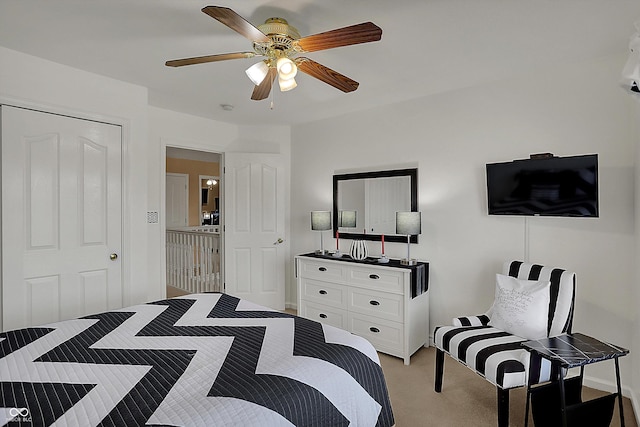 bedroom with a ceiling fan and light colored carpet