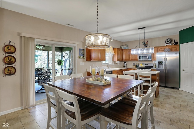 dining area featuring visible vents, baseboards, a chandelier, and light tile patterned floors