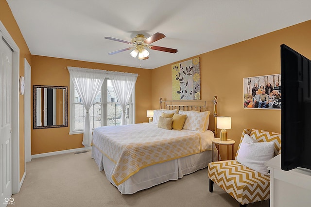 bedroom with baseboards, a closet, light carpet, a ceiling fan, and visible vents