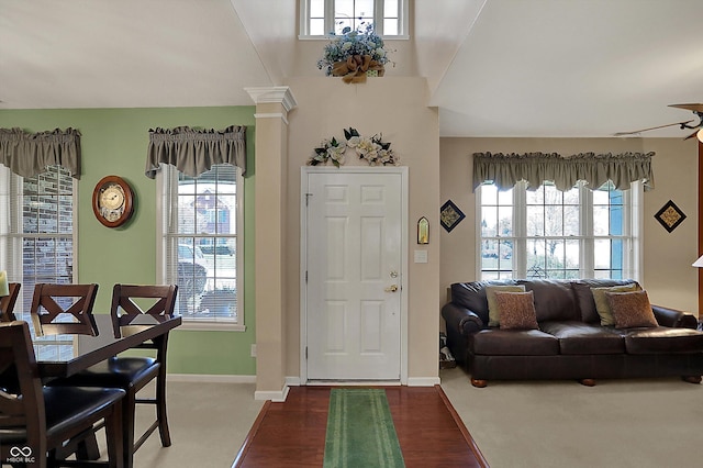 entryway with baseboards, decorative columns, and wood finished floors