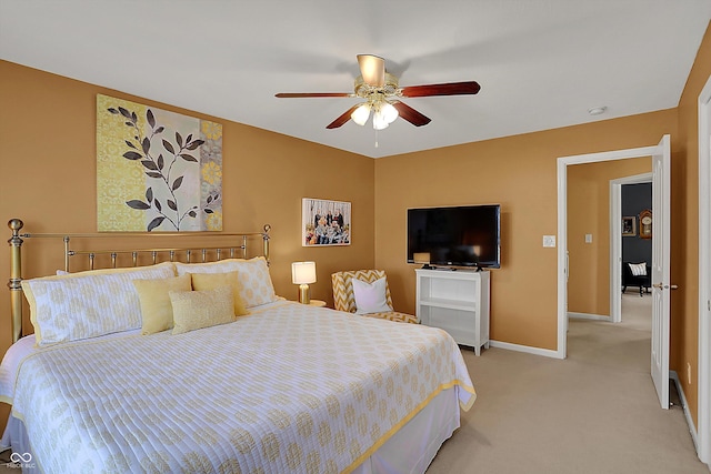 bedroom featuring baseboards, a ceiling fan, and light colored carpet