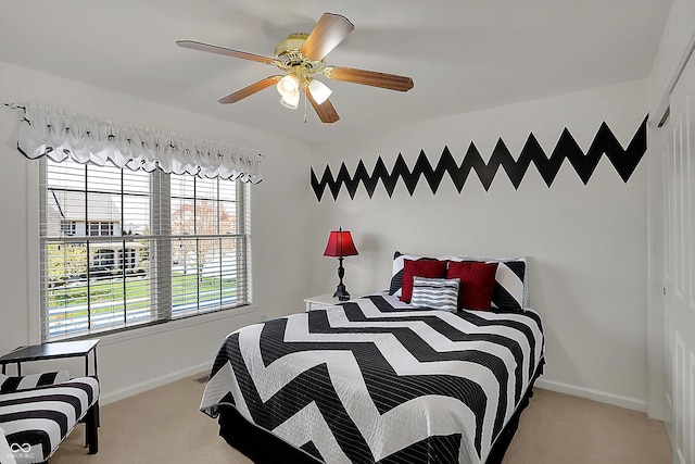 bedroom featuring baseboards, a ceiling fan, and carpet floors