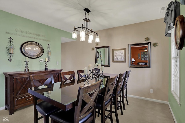 dining space with visible vents, baseboards, and light colored carpet