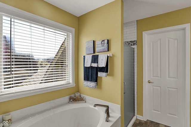 full bath featuring a shower stall and a garden tub