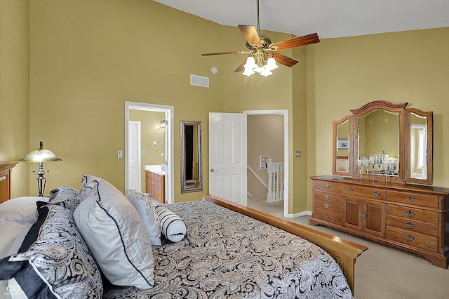 bedroom with visible vents, ceiling fan, ensuite bath, high vaulted ceiling, and light carpet