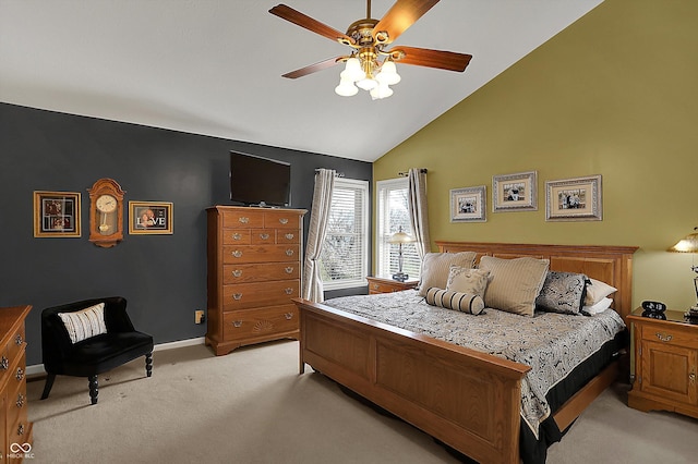 bedroom featuring light carpet, baseboards, a ceiling fan, and vaulted ceiling